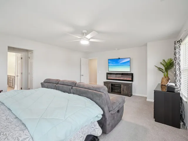 a bedroom with a large bed and a flat screen tv