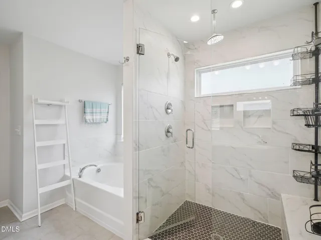 a bathroom with a bathtub and shower