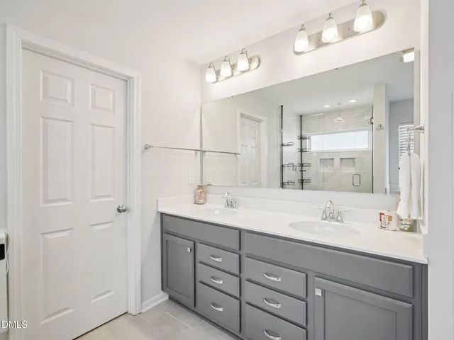 a bathroom with 2 sink and a mirror
