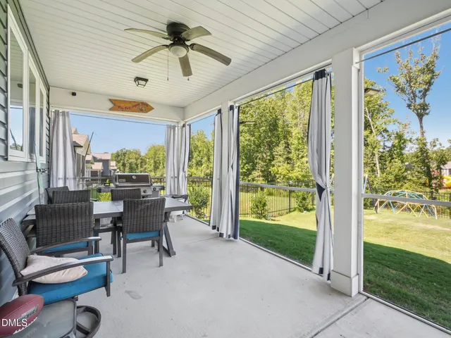 a view of a patio with table and chairs potted plants with wooden floor