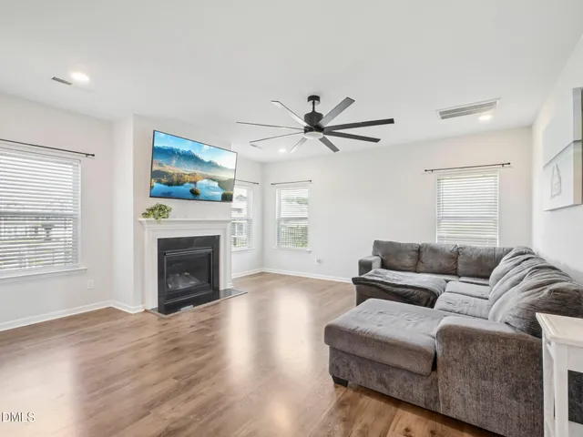 a living room with furniture a window and a fireplace