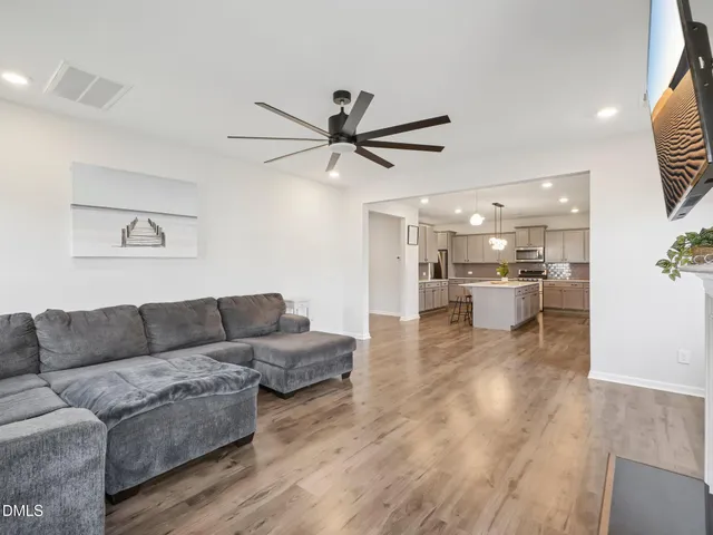 a living room with furniture and kitchen view
