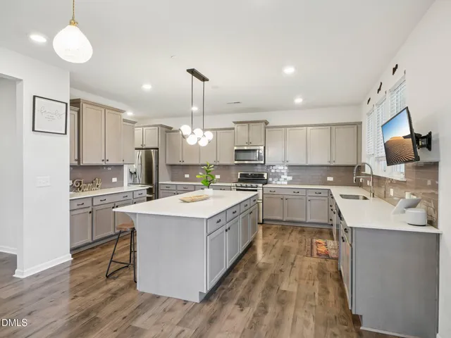 a kitchen with a sink stove cabinets and refrigerator