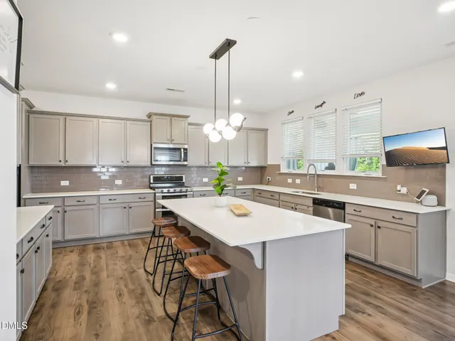 a kitchen with cabinets a sink and appliances