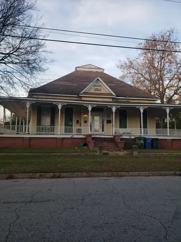 a front view of house with a garden
