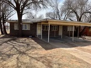 a front view of a house with a yard and glass windows