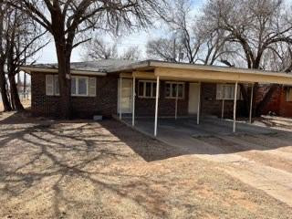 2101 35th Street Lubbock, TX 79412 - Photo 2 of 12 a front view of a house with a yard and glass windows