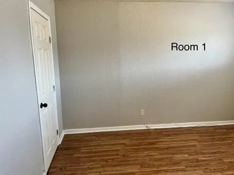 a view of a room with wooden floor