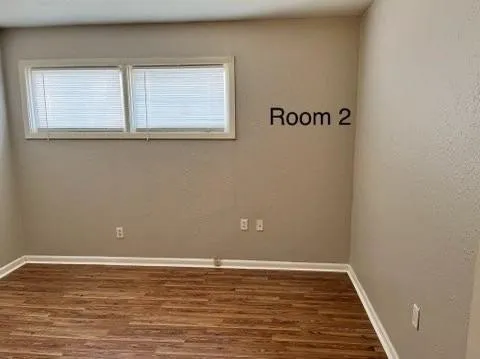 a view of a room with wooden floor and windows