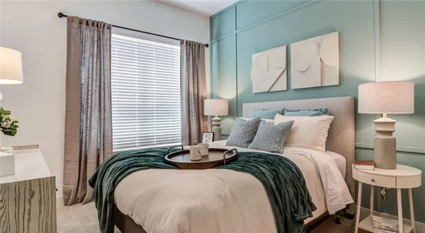 a bedroom with bed and a window
