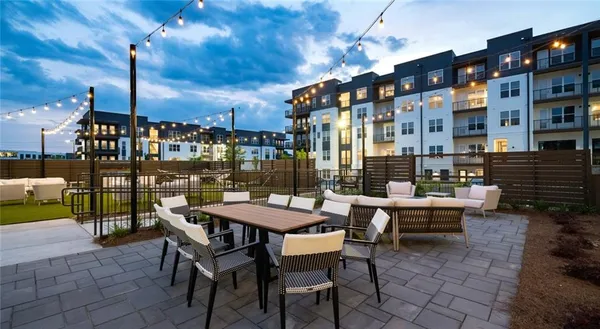 a view of a patio with a table and chairs and potted plants