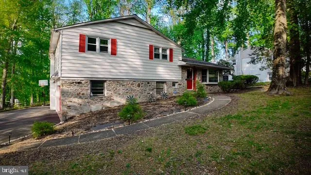a front view of house with yard and trees