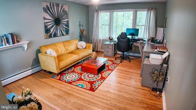 a living room with furniture rug and window