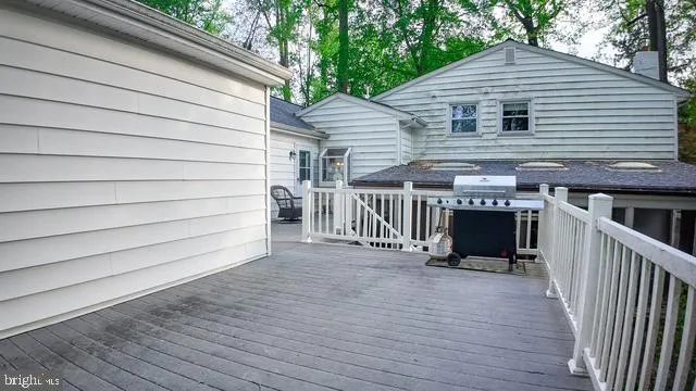 a view of house with deck and outdoor seating