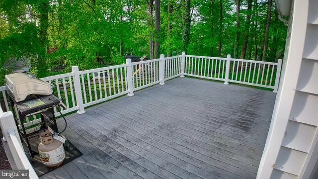 a view of a wooden deck and a backyard
