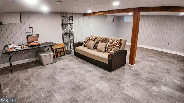 a sign board with yard and trees in the background