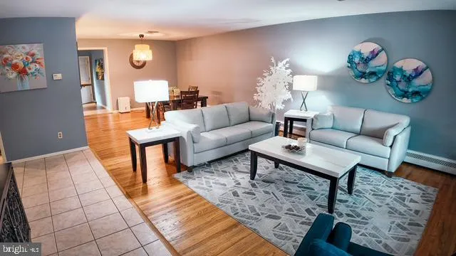 a living room with furniture and a potted plant