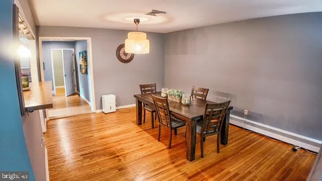 a view of a dining room with furniture and wooden floor