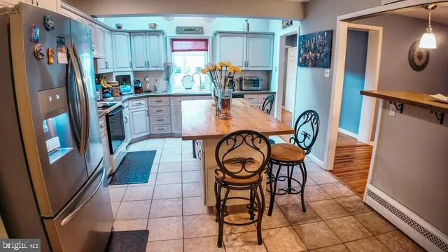 a dining room filled with furniture and wooden floor