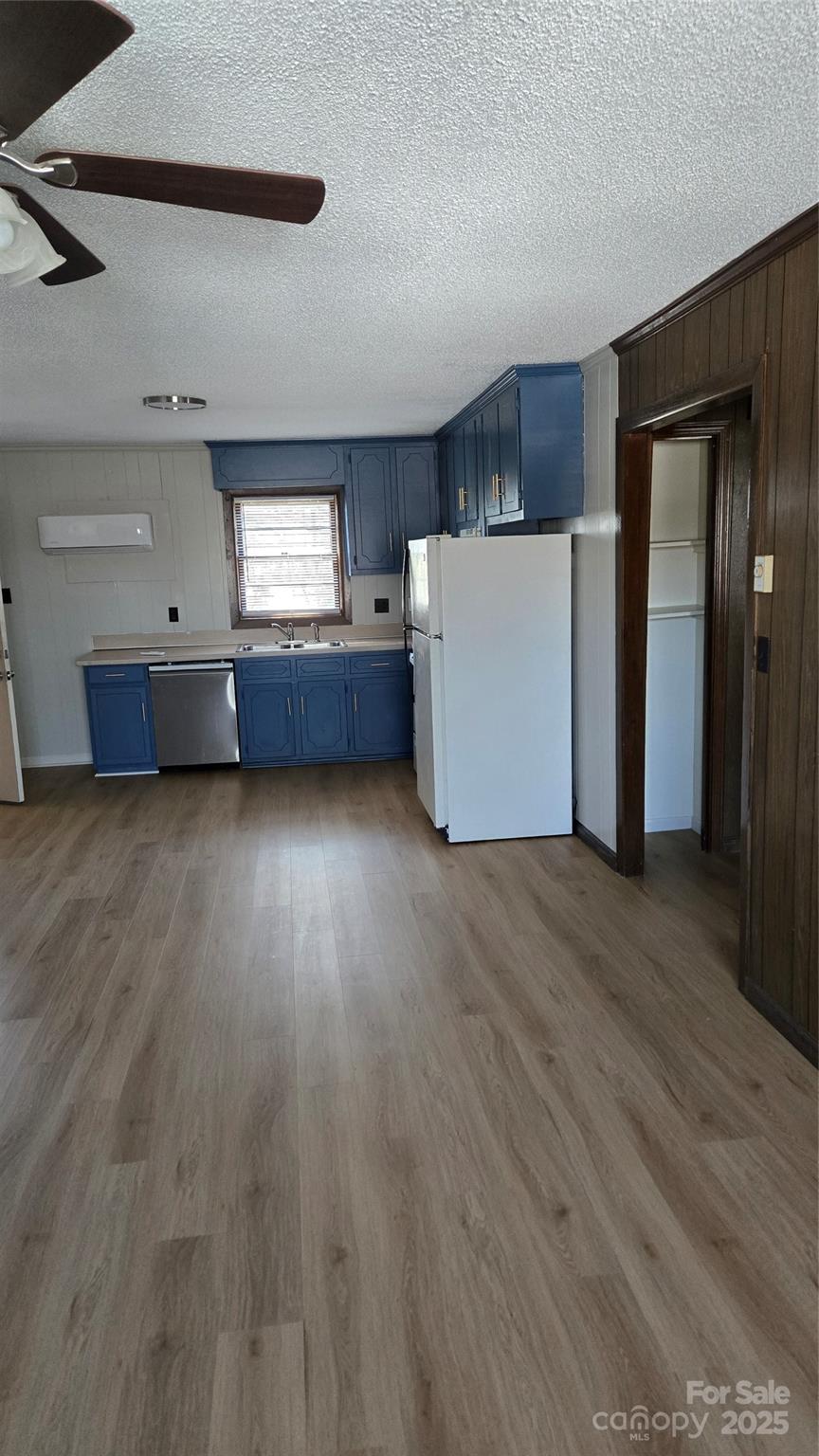 1554 Barringer Street Mount Pleasant, NC 28124 - Photo 4 of 6 a view of a kitchen with a fridge and wooden floor