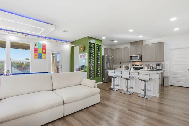a living room with kitchen island furniture and a wooden floor