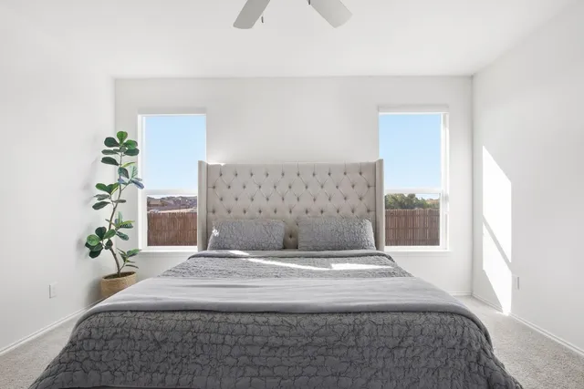 a bedroom with a bed and a potted plant