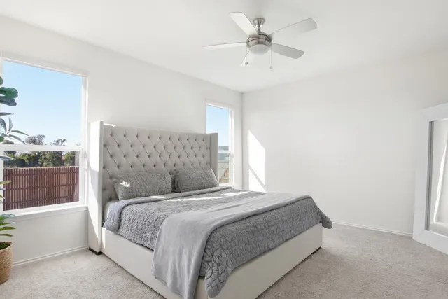 a bedroom with a large bed and a window