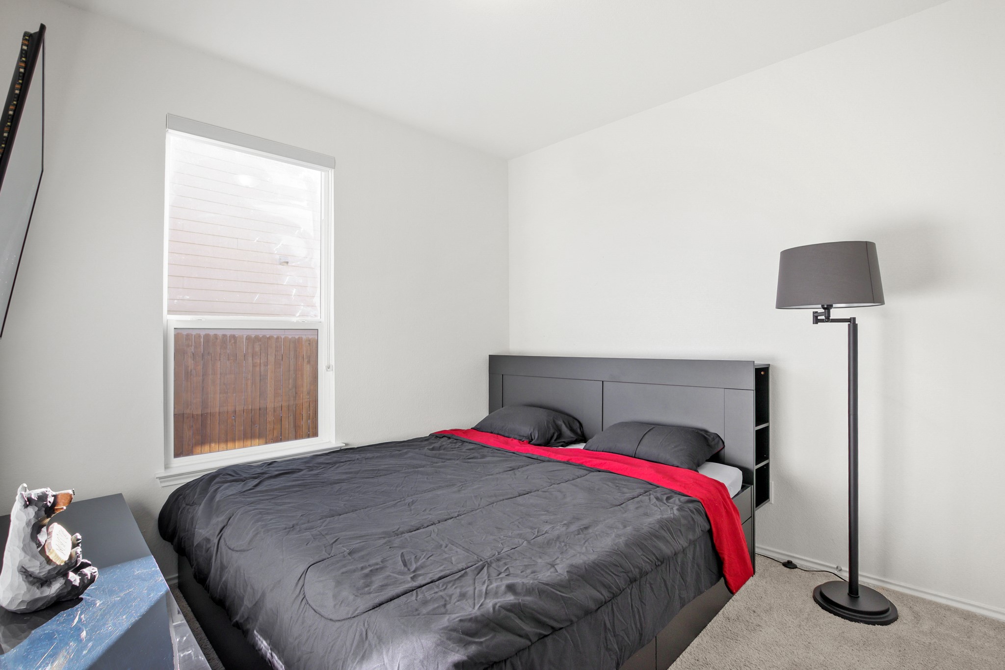 102 Whitney Drive Elgin, TX 78621 - Photo 15 of 24 a bedroom with a bed and a window