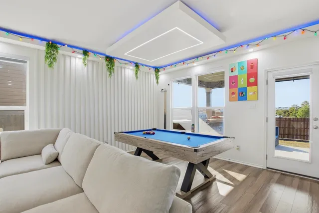 a living room with furniture and wooden floor