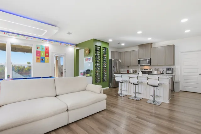 a living room with furniture and kitchen view