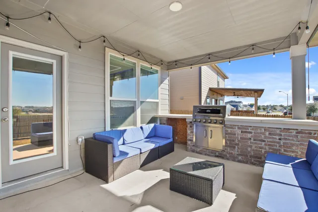 a living room with furniture and a floor to ceiling window