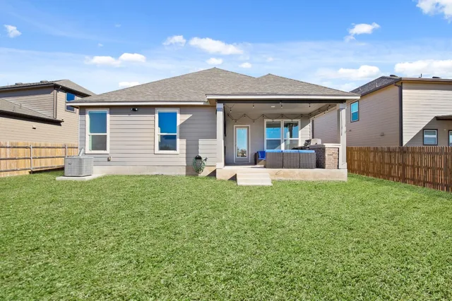 a view of a house with backyard and porch