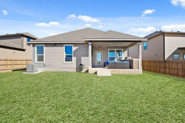 a view of a house with backyard and porch