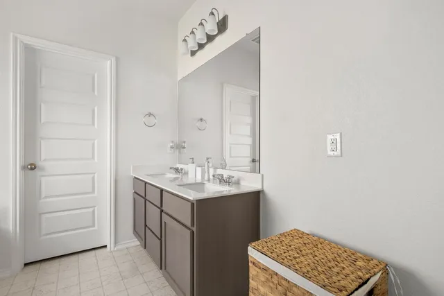 a bathroom with a sink a vanity and a mirror