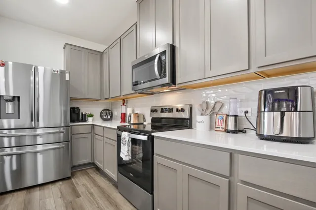 a kitchen with granite countertop stainless steel appliances and wooden cabinets