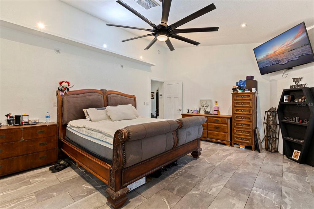 649 16th Street Northwest Largo, FL 33770 - Photo 17 of 42 a bedroom with a bed and a flat screen tv
