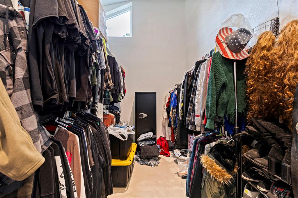 649 16th Street Northwest Largo, FL 33770 - Photo 20 of 42 a view of walk in closet with clothes
