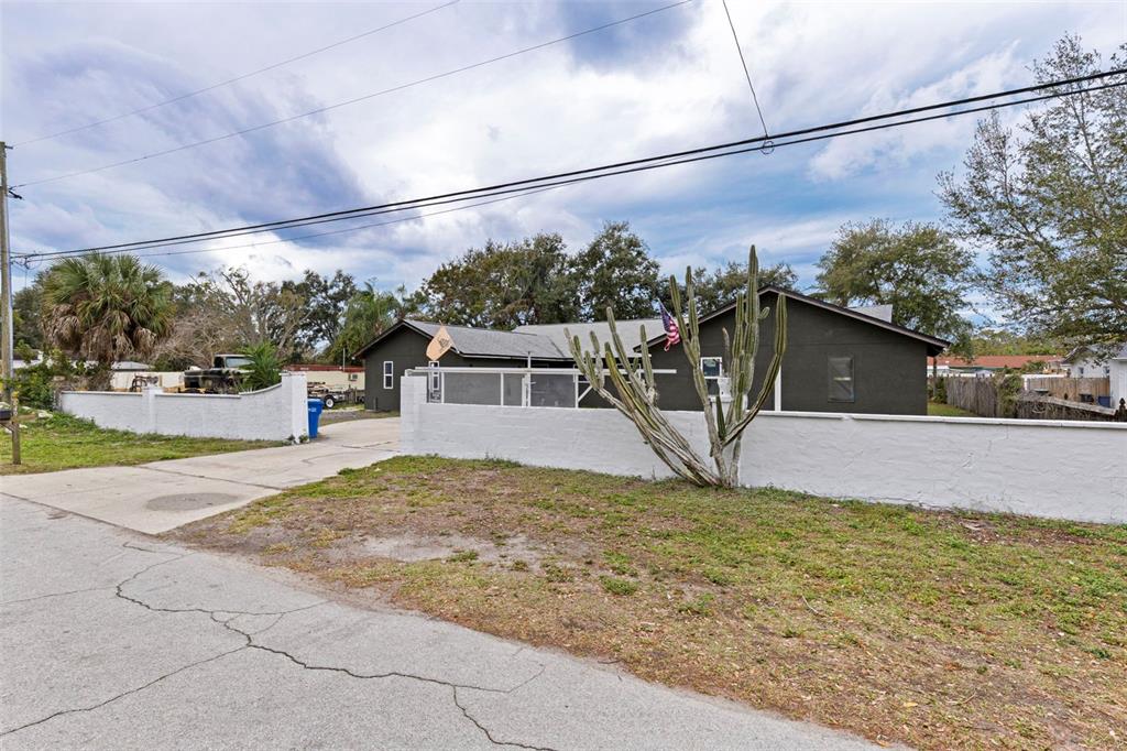 649 16th Street Northwest Largo, FL 33770 - Photo 2 of 42 a view of a house with a yard and a garage