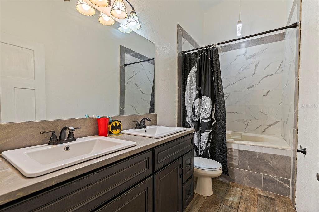 649 16th Street Northwest Largo, FL 33770 - Photo 23 of 42 a bathroom with a sink toilet and shower