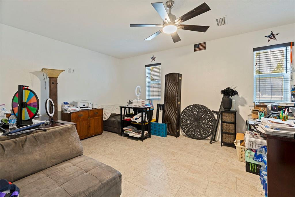 649 16th Street Northwest Largo, FL 33770 - Photo 27 of 42 a living room with furniture a ceiling fan and a window