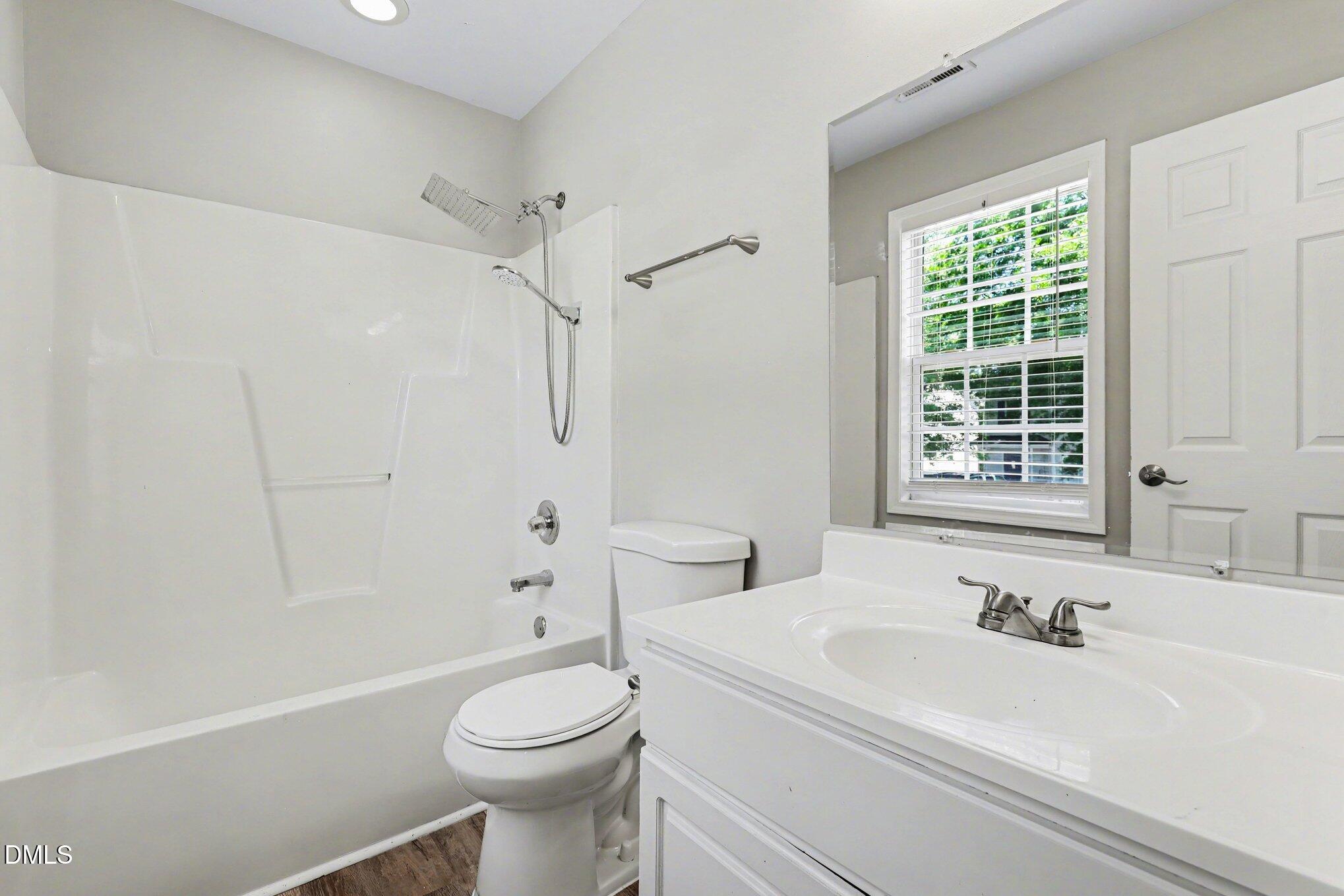 4816 Windbreak Lane Raleigh, NC 27616 - Photo 12 of 17 a bathroom with a sink a toilet and a bathtub