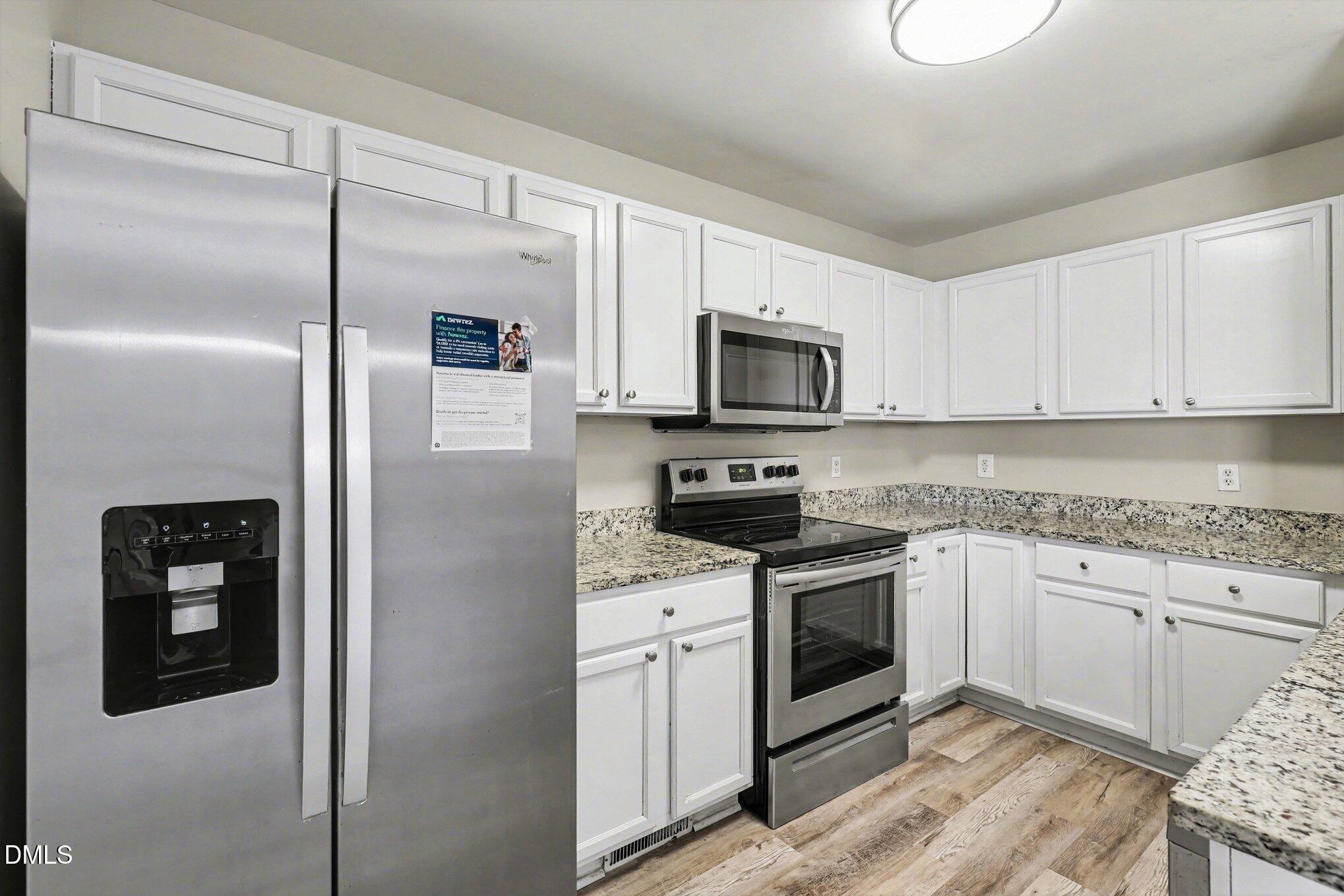 4816 Windbreak Lane Raleigh, NC 27616 - Photo 5 of 17 a kitchen with a refrigerator stove and microwave