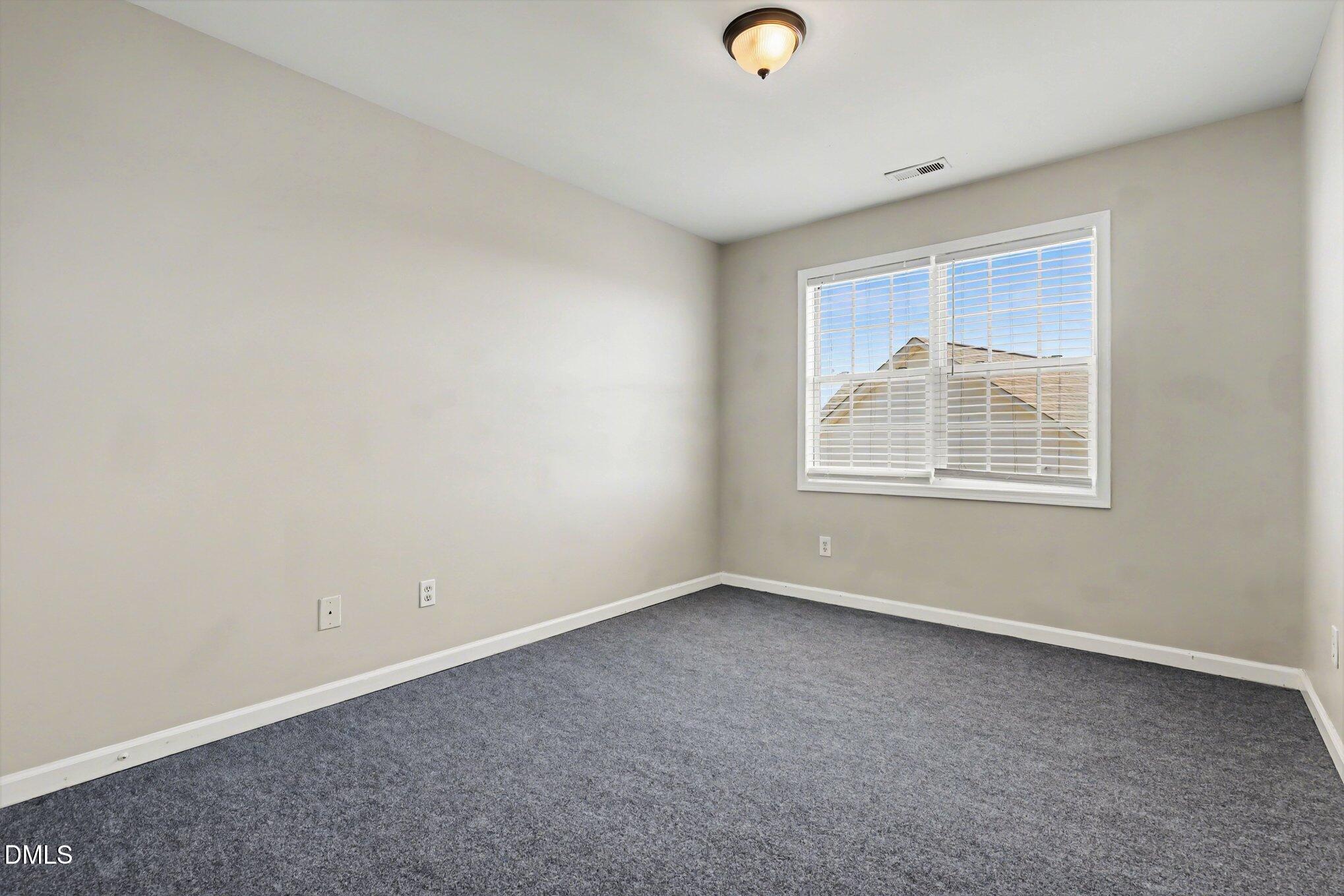 4816 Windbreak Lane Raleigh, NC 27616 - Photo 8 of 17 an empty room with windows