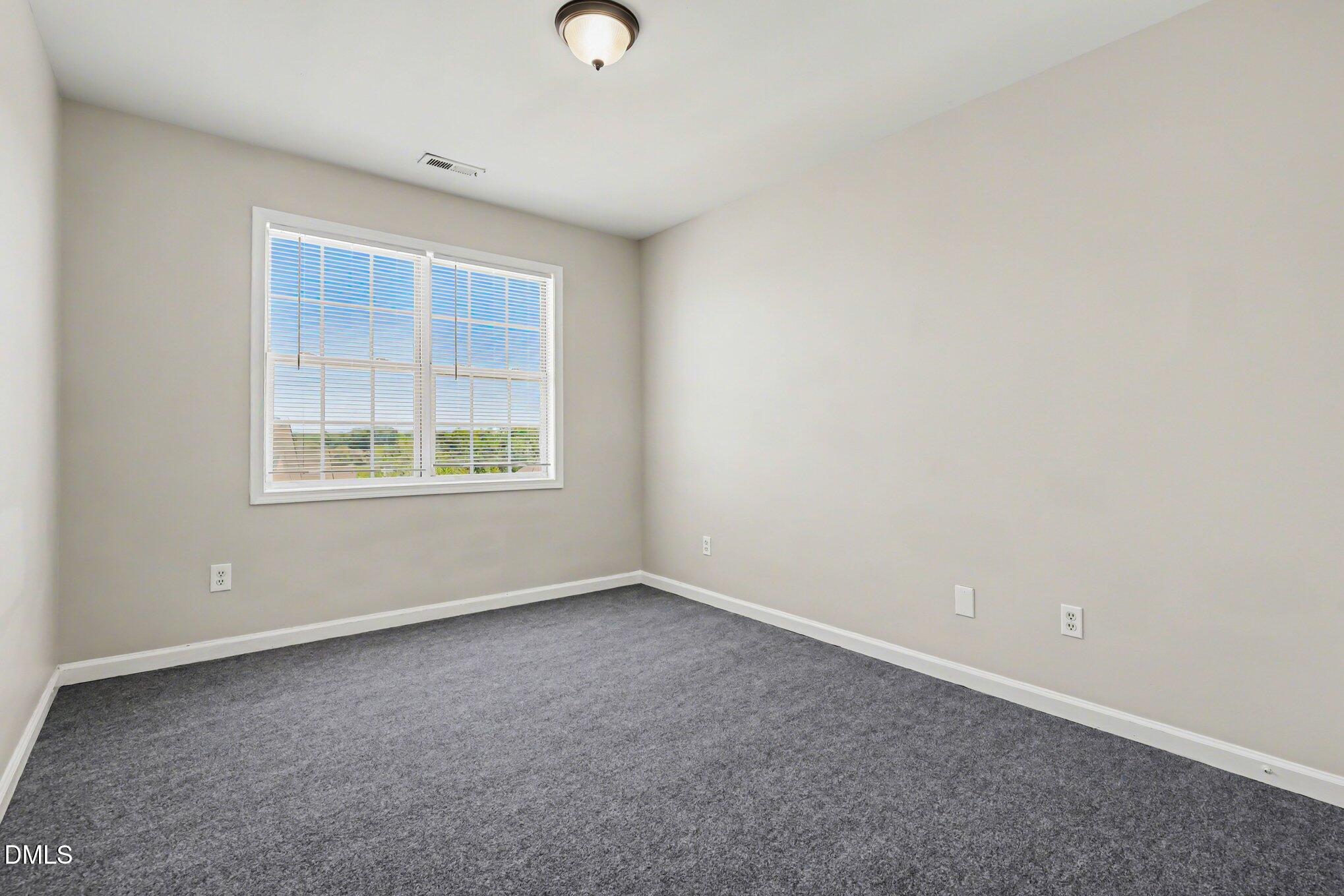 4816 Windbreak Lane Raleigh, NC 27616 - Photo 9 of 17 an empty room with a window