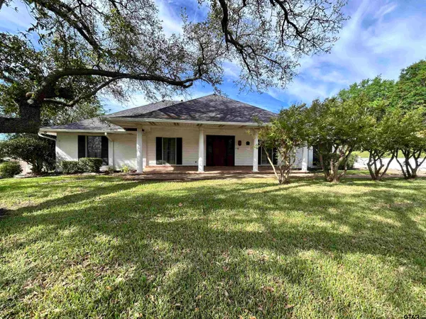 a view of a house with a yard patio and tree s