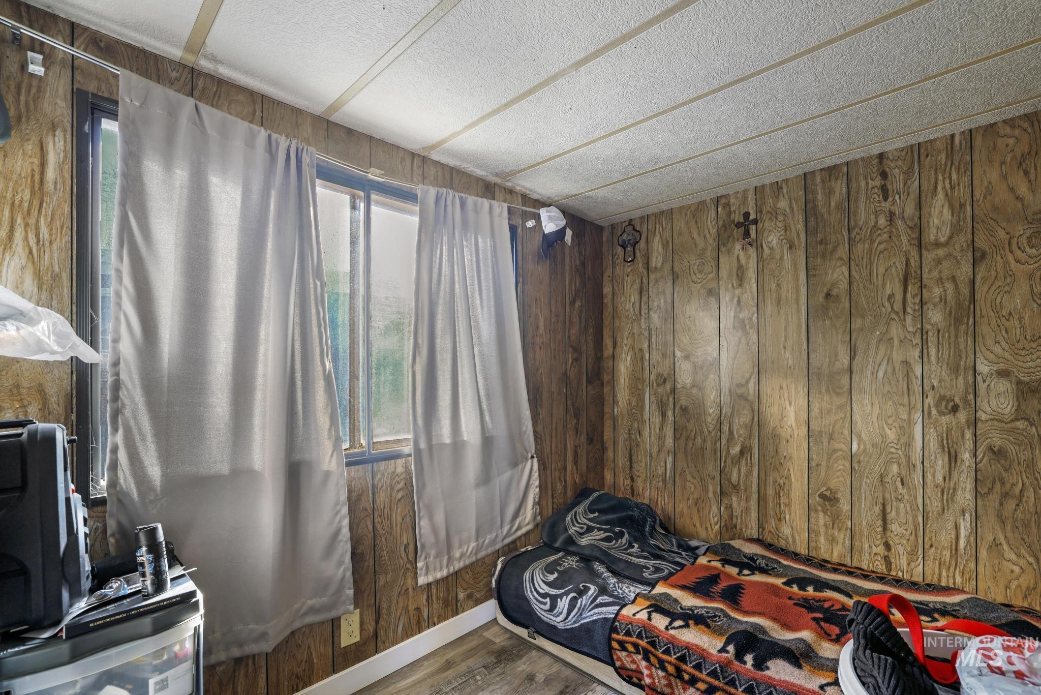 1625 Maple Street, Unit 20 Buhl, ID 83316 - Photo 14 of 17 Bedroom with wooden walls and wood finished floors