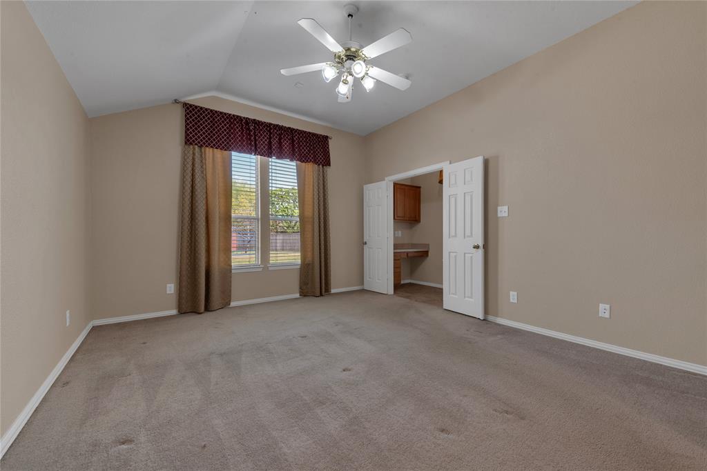 910 Derby Court Celina, TX 75009 - Photo 14 of 27 an empty room with chandelier fan and windows