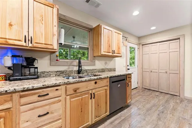 a kitchen with granite countertop white cabinets and white appliances