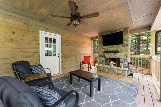 a living room with furniture a flat screen tv and a fireplace