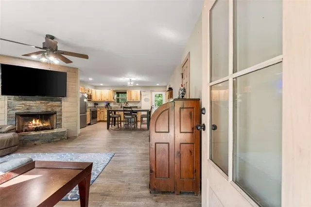a living room with furniture a flat screen tv and a fireplace
